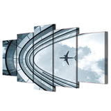 Airplane Flying Over Building 5 Piece Canvas Wall Art